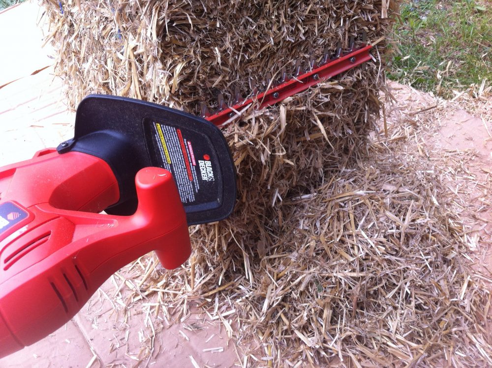 Straw is chopped with hedge trimmers into 1" to 3" pieces