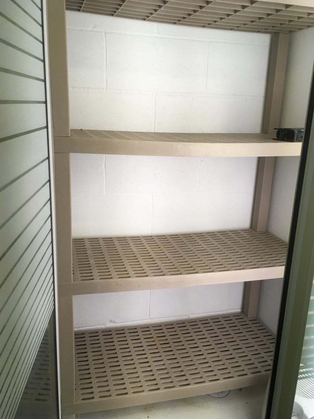 This plastic shelving unit just happened to fit perfectly! Perforations allow drainage and air circulation.